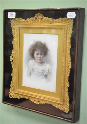 Lot 396 - A late 19th century head and shoulders portrait of a child, on porcelain, glazed and framed