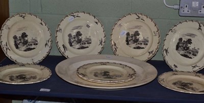 Lot 412 - A set of eight creamware plates, printed in black with landscapes within feather borders, 25cm...