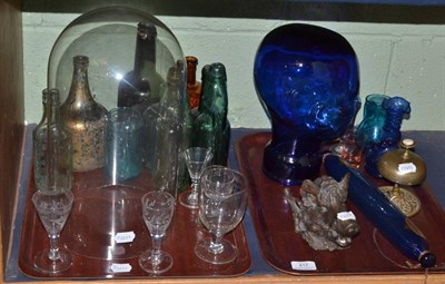 Lot 417 - Two trays including onion shaped bottle, glass dome, drinking glasses, blue glass rolling pin,...