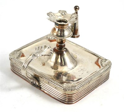 Lot 429 - A rare Old Sheffield Plate taper chamberstick, the rectangular base with shell capped corners...