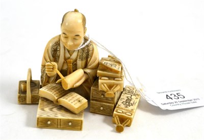 Lot 435 - A Japanese ivory okimono, Meiji Period, as a scholar seated writing on a scroll, books and...