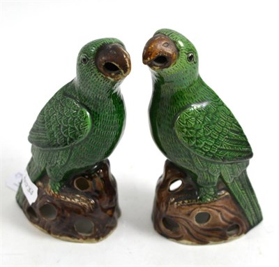 Lot 437 - Pair of Chinese Qing dynasty enamelled biscuit porcelain parrots