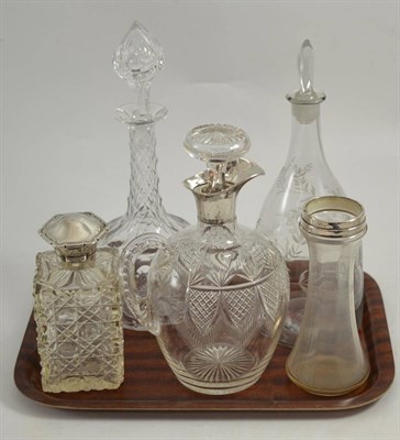 Lot 515 - * A cut glass decanter with silver mount, a cut glass claret jug with silver mount, a glass...