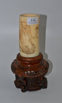 Lot 516 - * A late 19th century Japanese ivory vase decorated with an elephant and three tigers raised on...