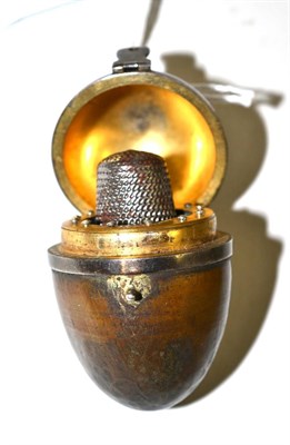 Lot 538 - A 19th century sewing companion in the form of an egg shaped casket with hinged lid