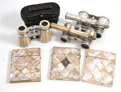 Lot 545 - * Two mother-of-pearl opera glasses with folding handles, another pair in a fitted leather case and