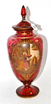 Lot 563 - * A late 19th century ruby glass vase and cover decorated with an oval panel depicting a girl, 48cm