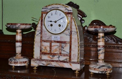 Lot 570 - An Art Deco marble striking mantel clock with garniture, enamel dial, twin barrel movement striking