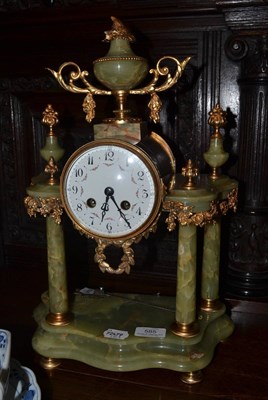 Lot 585 - A green onyx striking mantel clock, circa 1910, portico case with floral gilt metal mounts,...