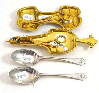 Lot 594 - Two brass snuffers and two George III spoons