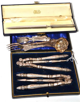 Lot 600 - A cased set of nutcrackers, six silver dessert forks, a strainer spoon, two pickle forks and a...