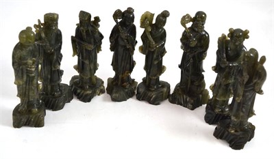 Lot 613 - A set of eight Chinese carved green soapstone figures of immortals, 20th century, each with...