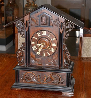 Lot 655 - A Black Forest cuckoo clock, circa 1890, applied leaf mounts, 5-1/2-inch dial, twin barrel movement