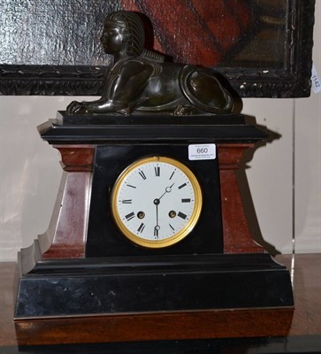 Lot 660 - A Egyptian revival black slate and marble striking mantel clock, circa 1870, surmounted by a bronze