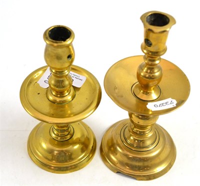 Lot 672 - Two 17th century brass candlesticks