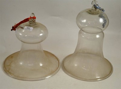 Lot 680 - * Two late George III clear glass bell-shaped smoke domes, 27cm and 24cm diameter