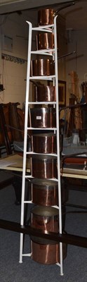 Lot 695 - Set of ten graduated pans with stand