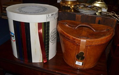 Lot 696 - Leather hat box and two top hats