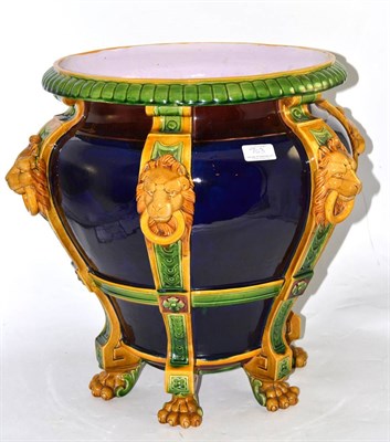 Lot 703 - A Minton jardiniere circa 1870 moulded with ring and lion masks and raised on paw feet