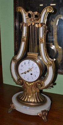 Lot 724 - A marble and gilt metal striking lyre clock, circa 1900, lyre shaped case with applied swag and...