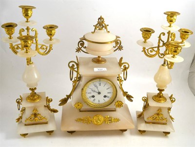 Lot 727 - An onyx striking mantel clock with garniture, circa 1910, gilt metal mounts, enamel dial, twin...