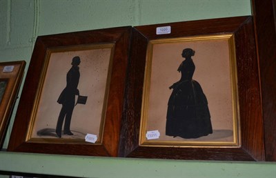 Lot 1220 - A pair of 19th century rosewood framed silhouette portraits depicting a gentleman and a lady