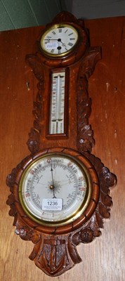 Lot 1236 - A combined timepiece/barometer and thermometer wall piece, circa 1910, carved oak case, enamel...