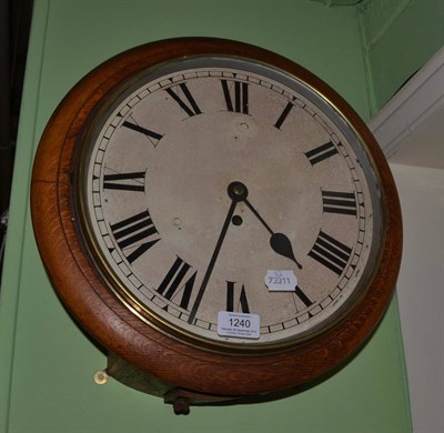 Lot 1240 - An oak wall timepiece, early 20th century, side and bottom doors, 12-inch painted dial, single...