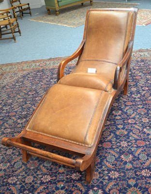 Lot 1241 - A 20th century chaise longue covered in brown leather