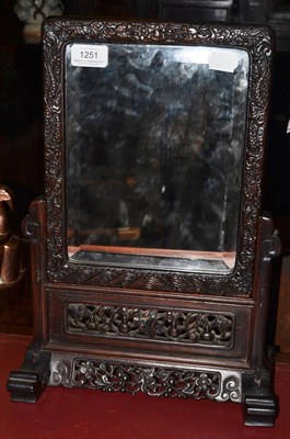 Lot 1251 - Late 19th century Chinese hardwood foliate carved mirror, 43cm high