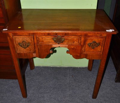 Lot 1257 - * A George III walnut low boy fitted with three drawers, 81cm wide