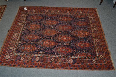 Lot 1269 - Afshar rug, South East Persia, the indigo field with tribal motifs around columns of heraldic...