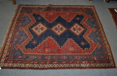 Lot 1279 - Afshar rug, South East Persia, the deep indigo field with three hooked diamond medallions framed by