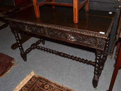 Lot 1297 - A 19th century carved oak hall table with two drawers