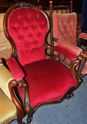 Lot 1311 - A Victorian walnut framed armchair upholstered in button back velvet