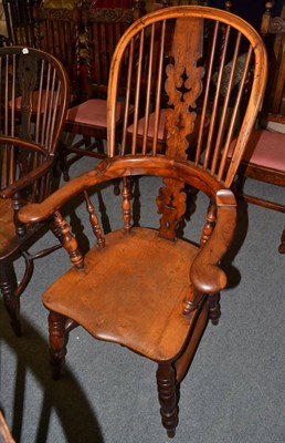 Lot 1312 - A 19th century yew wood broad-arm Windsor chair