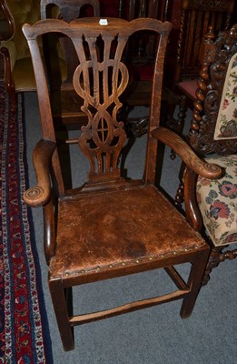 Lot 1317 - A George III Provincial oak armchair with close nailed leather seat