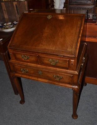 Lot 1333 - A walnut bureau on stand in George II style