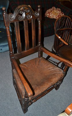 Lot 1341 - An English joined oak armchair with leather seat