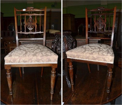 Lot 1365 - A pair of Edwardian rosewood bedroom chairs with delicately carved backs