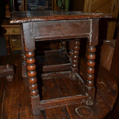 Lot 1372 - A joined oak coffin stool, basically 17th century with bobbin turned legs