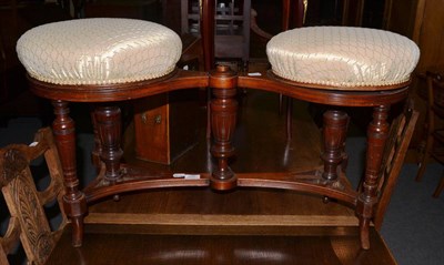 Lot 1382 - A late Victorian walnut revolving duet stool, covered in cream silk fabric, raised on turned...