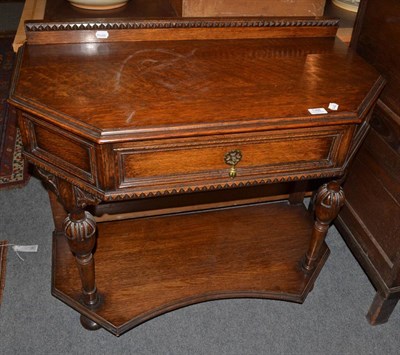 Lot 1388 - An oak credence table with canted corners, fitted with a drawer and lower platform