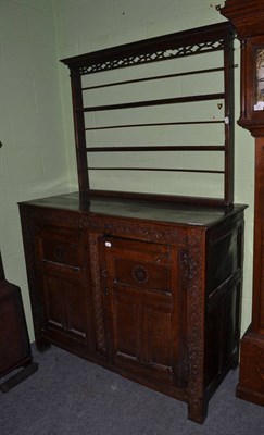 Lot 1402 - An 18th century joined oak cupboard fitted two doors and an associated small Delft rack