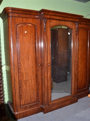 Lot 1404 - A Victorian mahogany breakfront wardrobe with mirrored centre door