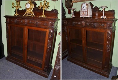 Lot 1412 - A pair of Victorian carved oak glazed bookcases