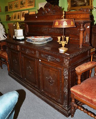 Lot 1413 - A carved oak sideboard/buffet