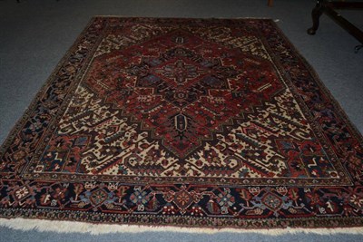 Lot 1478 - Heriz carpet of unusual proportions, Persian Azerbaijan, the raspberry field of angular vines...