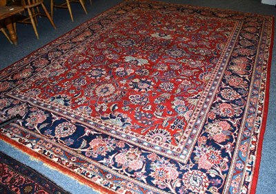 Lot 1482 - Kashan carpet, Central Persia, the blood red field with an allover design of scrolling vines...