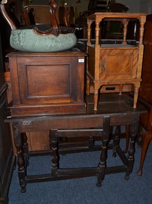 Lot 1489 - * An oak dining table lacking drop leaves, satin birch bedside cabinet, mahogany cupboard and a...